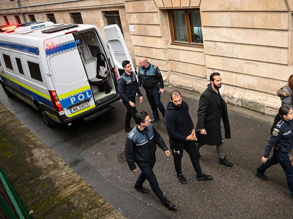 Andrew Tate (center left) and his brother Tristan Tate (center right) arrive at the Court of Appeal in Bucharest, Romania, on Feb. 27, 2023.