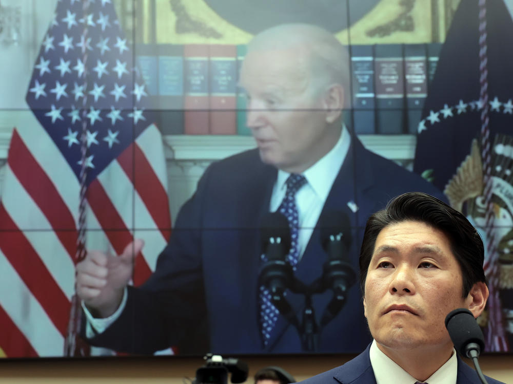 Robert Hur, the special counsel who led an investigation into President Biden's handling of classified documents, testifies alongside video of Biden to the House Judiciary Committee on Tuesday in Washington, D.C.
