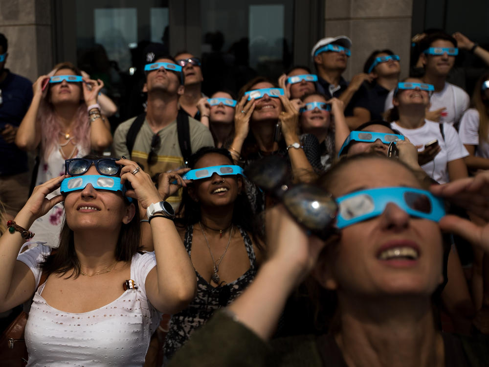 People view a total solar eclipse at from the observatory at Rockefeller Center in New York City on Aug. 21, 2017.