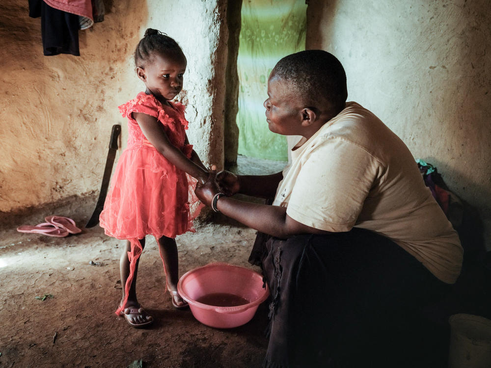 Isabela Oside, 45, washes hands of her daughter Faith, 3, who completed doses through the worlds first malaria vaccine. Malaria is one of the preventable diseases that contributes to worldwide child mortality.