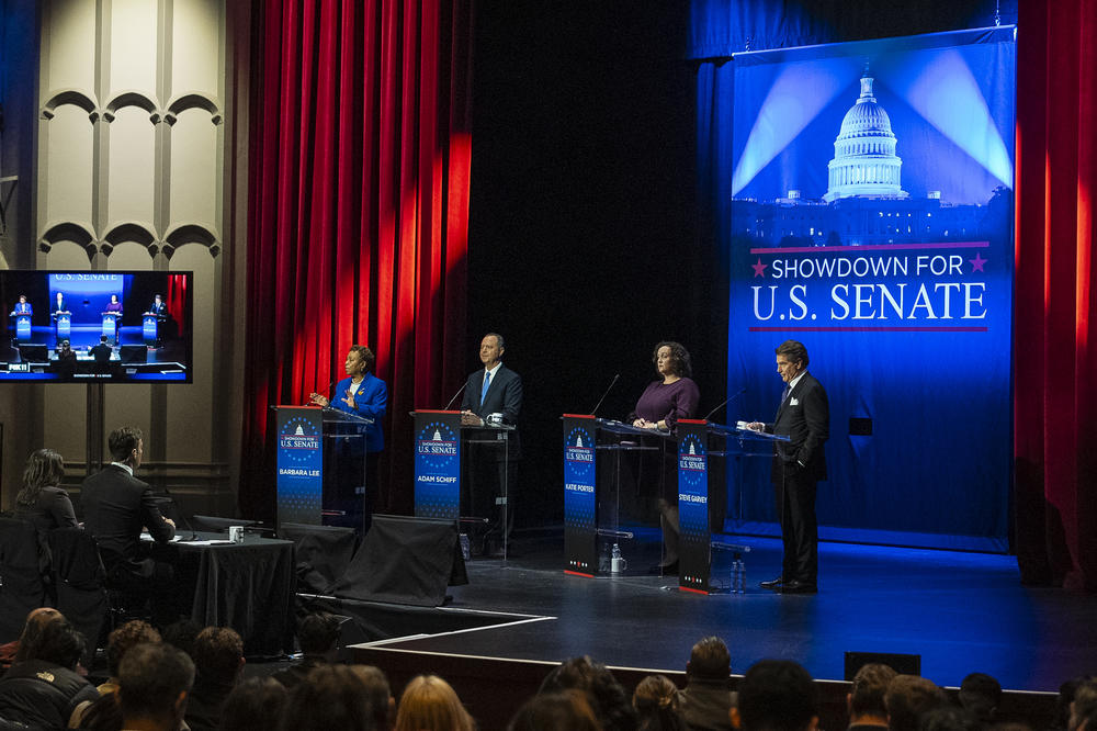 Candidates, from left, Rep. Barbara Lee, D-Calif., Rep. Adam Schiff, D-Calif., Rep. Katie Porter, D-Calif., and former baseball player Steve Garvey, stand on stage during a televised debate Jan. 22 in Los Angeles.