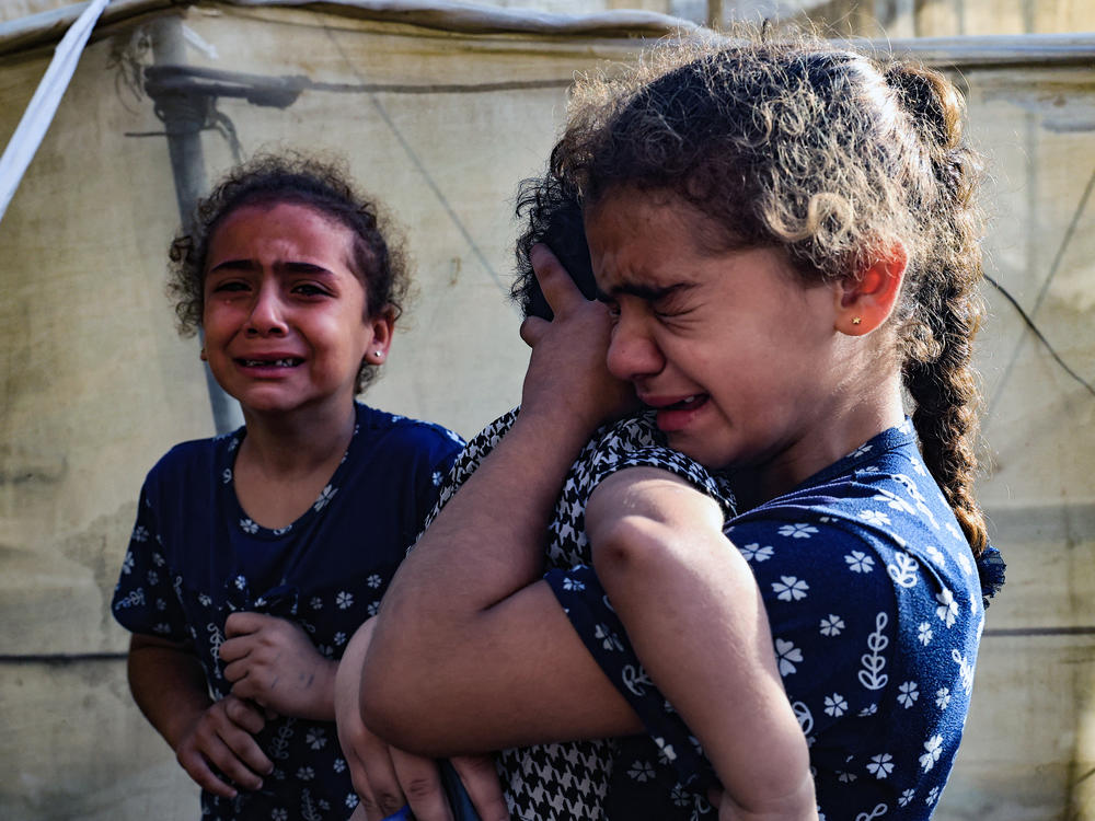 Children react during the funeral of the Faojo family, killed in an Israel strike on Rafah in the southern Gaza Strip on Nov. 11, 2023. Roughly 600,000 children are sheltering in Rafah, where a spiraling humanitarian crisis is playing out due to the war between Israel and Hamas.