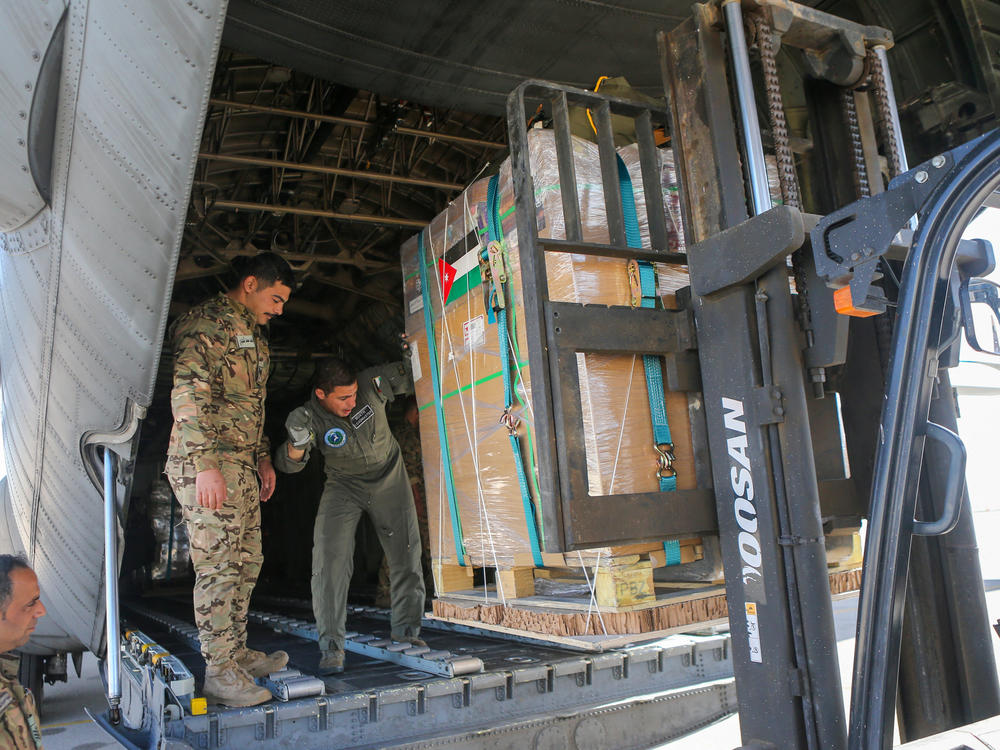 Humanitarian aid for Palestinians on the Gaza Strip is loaded onto a Jordanian Air Force aircraft in Amman on March 10, amid ongoing battles between Israel and the militant group Hamas.