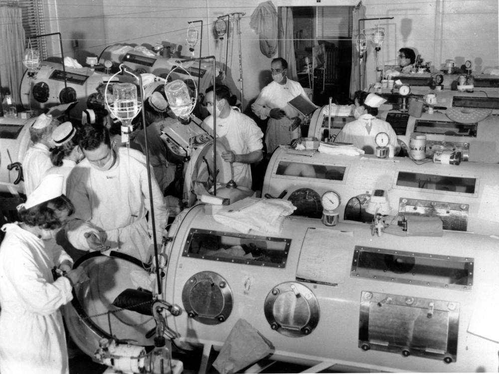 Paul Alexander, who held a Guinness World Record for living the longest with the help of an iron lung, has died. Here, medical staff stand among iron lung machines in an emergency polio ward at Haynes Memorial Hospital in Boston, Mass., on Aug. 16, 1955, when the city's polio epidemic hit a high of 480 cases.