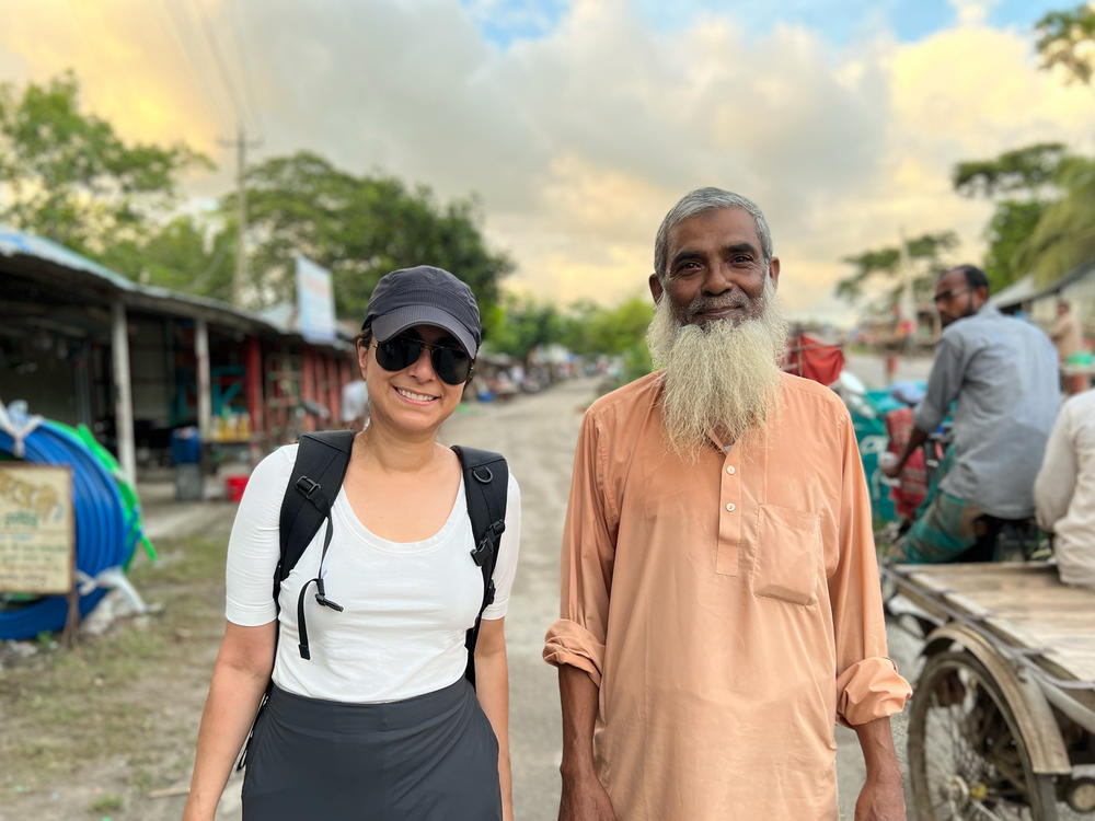 Physician and podcast Céline Gounder traveled to Bangladesh in 2022 to track down South Asian public health workers who were part of the battle to end smallpox nearly 50 years ago. Gounder is pictured with Delowar Hossain, who was part of the smallpox eradication campaign.