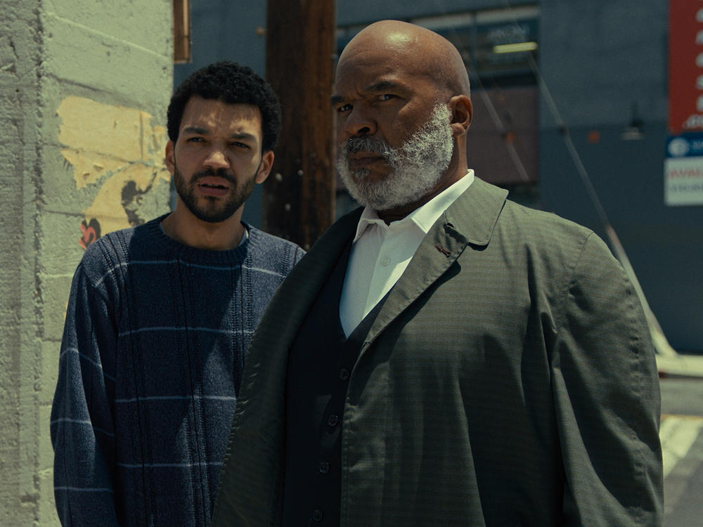 Aren (Justice Smith) and Roger (David Alan Grier) in <em>The American Society of Magical Negroes.</em>