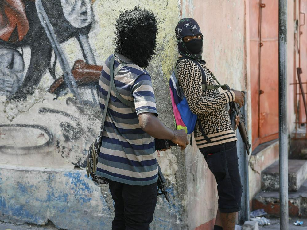 Members of the G9 and Family gang stand guard at their roadblock in the Delmas 6 neighborhood of Port-au-Prince, Haiti, Monday, March 11.