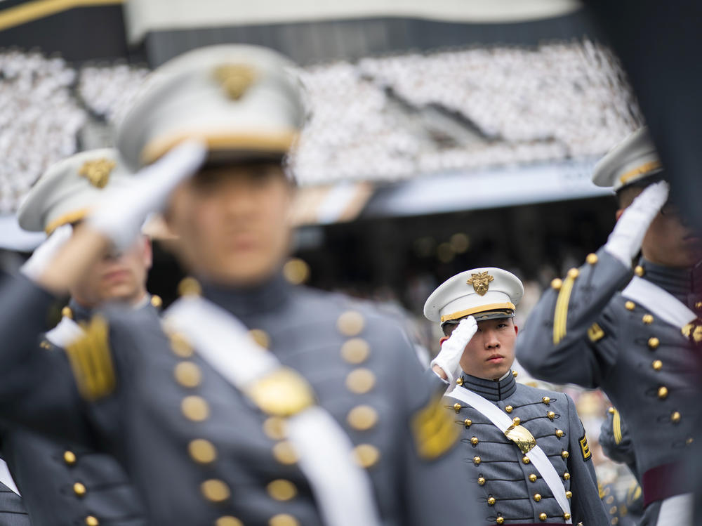 Cadets salute during the graduation ceremony at the U.S. Military Academy in 2021. A change to West Point's mission statement has sparked outrage among some conservatives online.