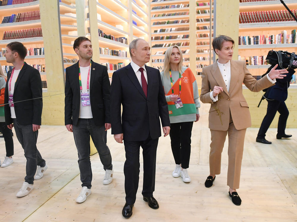 Putin tours the venue of the 2024 World Youth Festival during a visit to Sochi on March 6, in this photo distributed by a Russian state-owned agency.