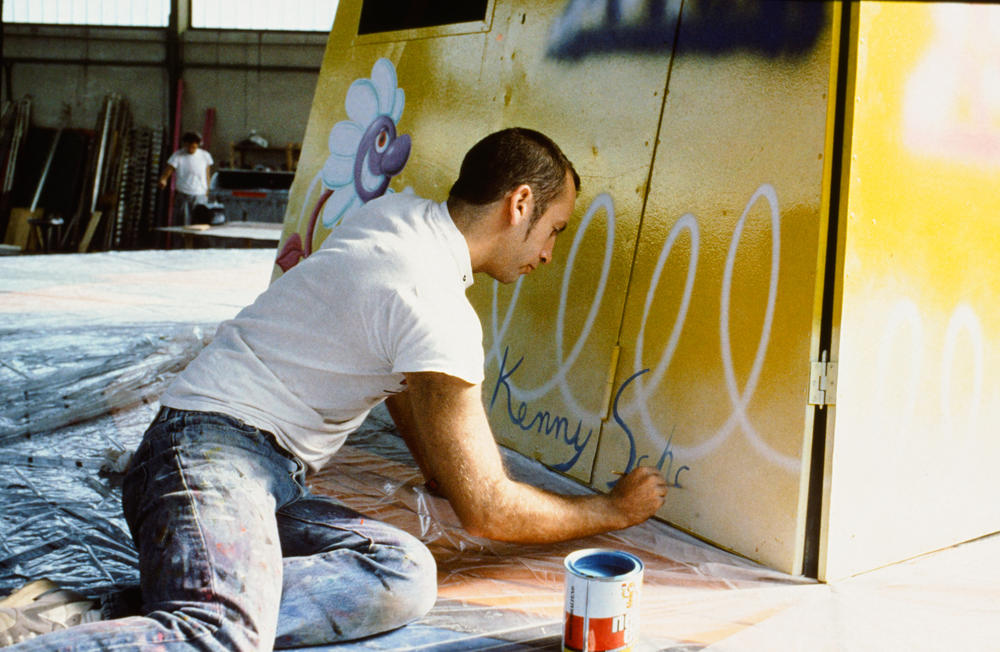 Kenny Scharf works on his painted swing ride for the original Luna Luna.