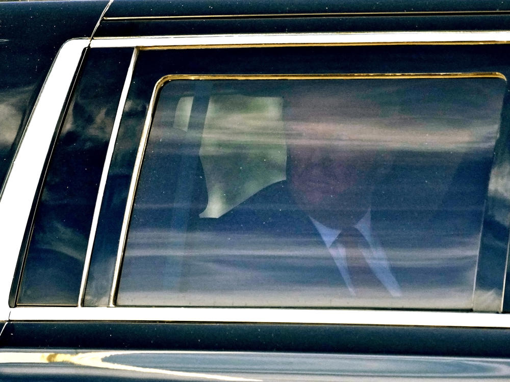 Former President Donald Trump waves to supporters as he leaves federal courthouse in Fort Pierce, Fla., on Thursday.