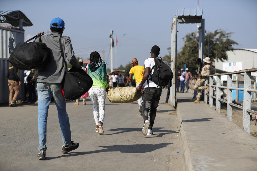 Haitian citizens cross over the border from the Dominican Republic into Haiti on Wednesday.