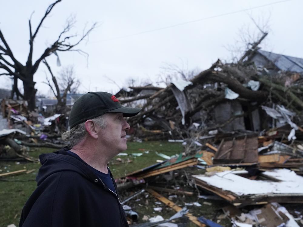Greg McDougle walks near debris on Friday, following a severe storm in Lakeview, Ohio.