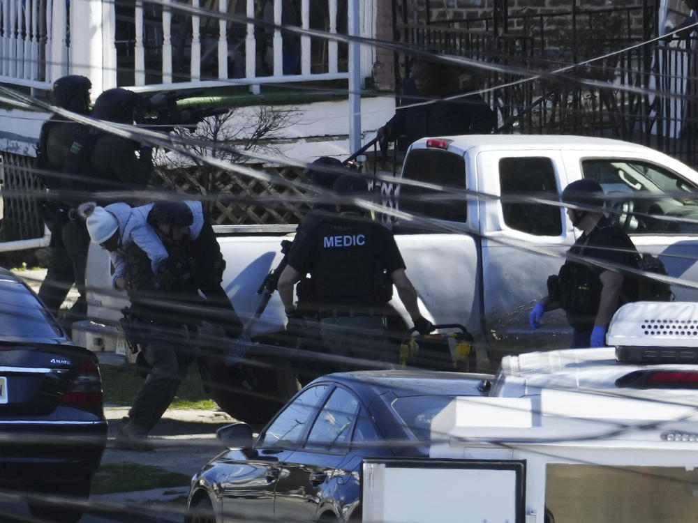 A resident is evacuated from a home in Trenton, N.J. on Saturday.