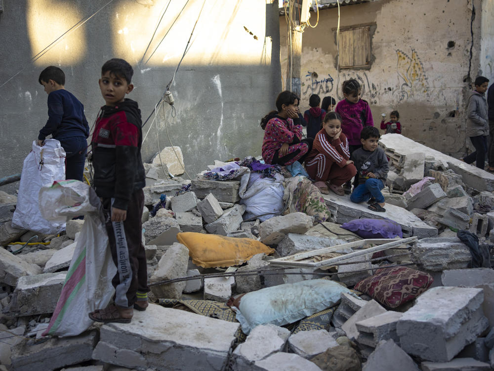 Palestinian children look at the destruction after an Israeli strike in Rafah, in southern Gaza, on Dec. 29.