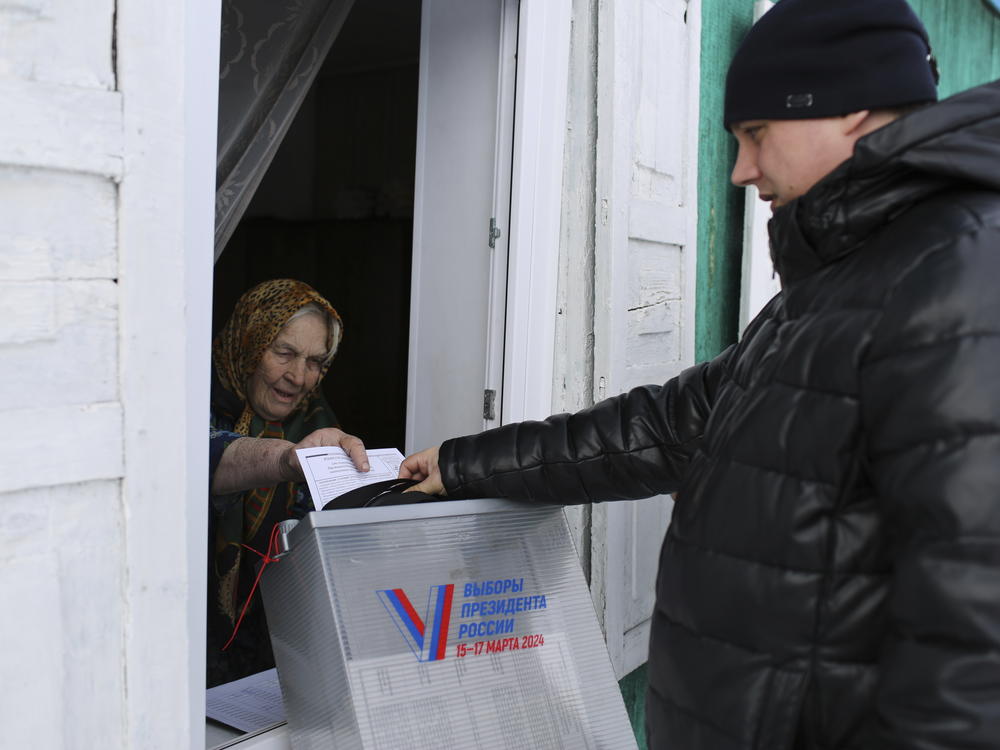 An elderly woman casts a ballot during a presidential election via a mobile election committee, who visit people who cannot physically attend a polling station, in Nikolayevka village outside Siberian city of Omsk, 2236 km (1397 miles) east of Moscow, Russia, on Saturday.