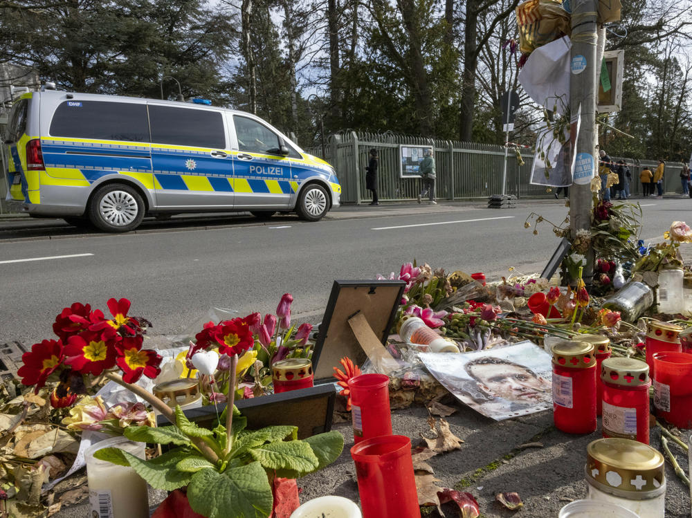 Flowers and candles are laid in front of the Russian Consulate General in memory of Alexei Navalny, in Bonn, Germany, on Sunday.