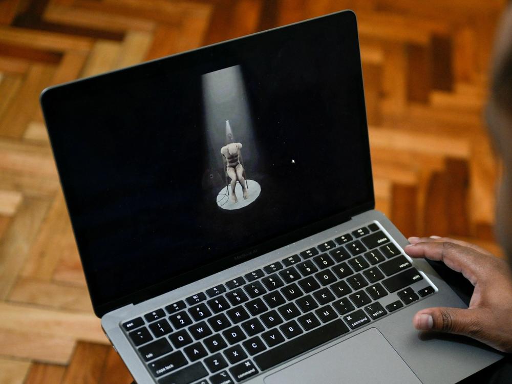 Víctor Navarro shows on his laptop part of the virtual reality tour of Venezuela's El Helicoide prison.