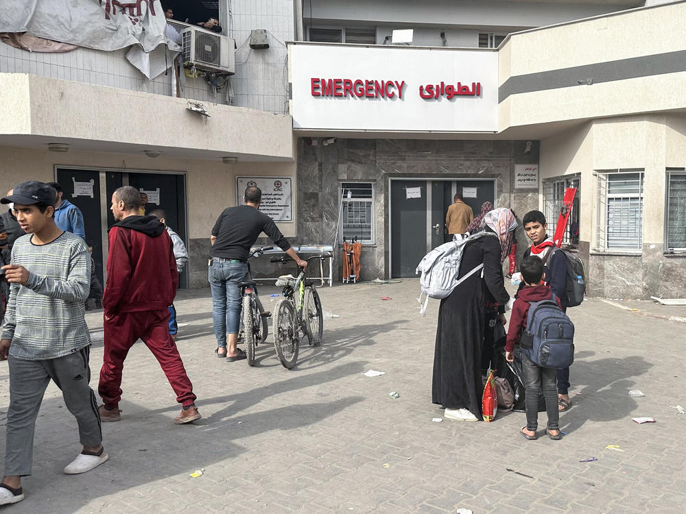 Displaced Palestinians gather in the yard of Gaza's Al-Shifa hospital on Dec. 10, 2023. The hospital, Gaza's largest, war raided by the Israeli military early on Monday.