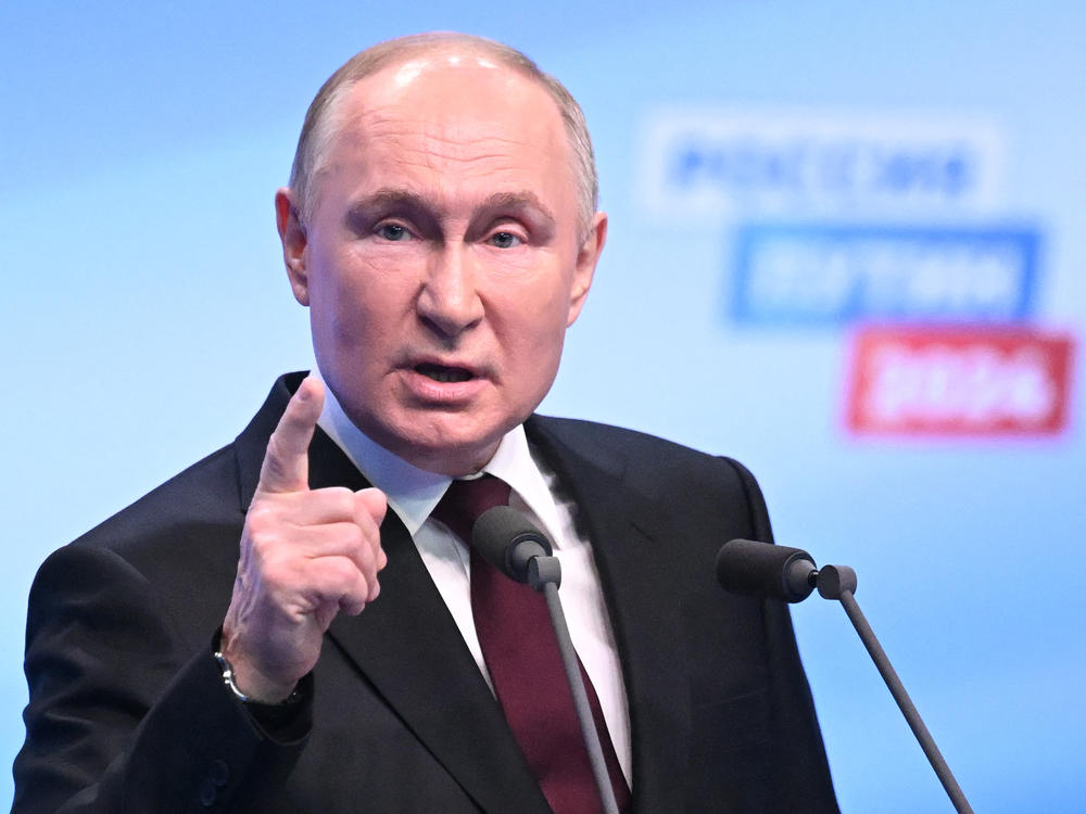 Russian President and presidential candidate Vladimir Putin meets with the media at his campaign headquarters in Moscow on Monday.