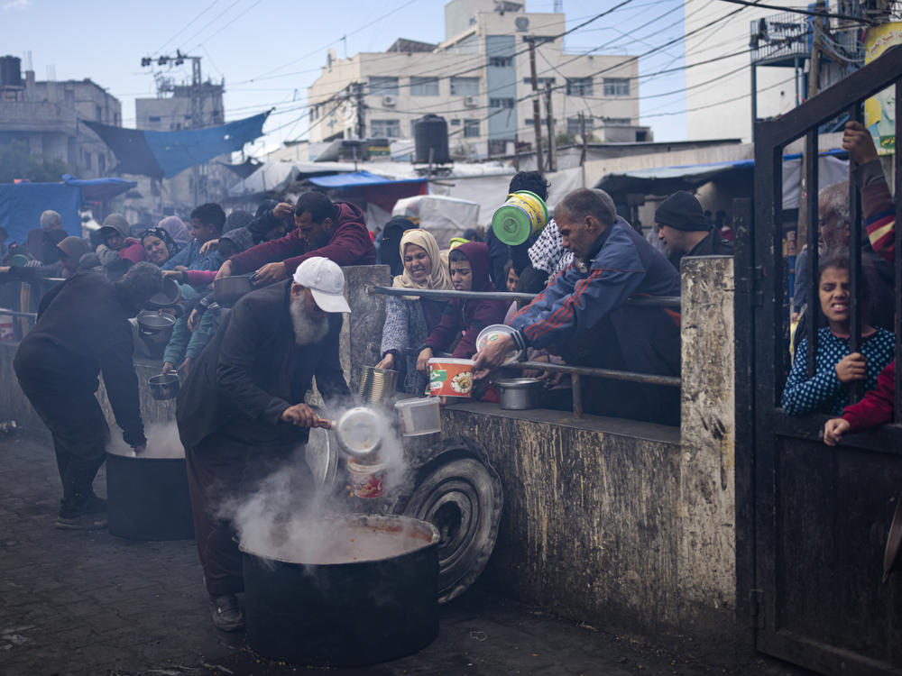 Palestinians line up for a free meal in Rafah on Feb. 16. International aid agencies say Gaza is suffering from shortages of food, medicine and other basic supplies as a result of the war between Israel and Hamas.