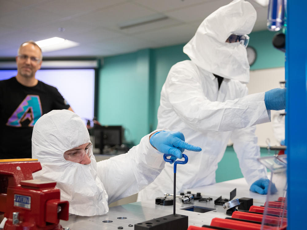 Brad Gist, 30, works with Liam Levinson, 28, during a lab for a 10-day semiconductor course at Chandler Gilbert Community College in Mesa, Ariz., on Oct. 11, 2023.