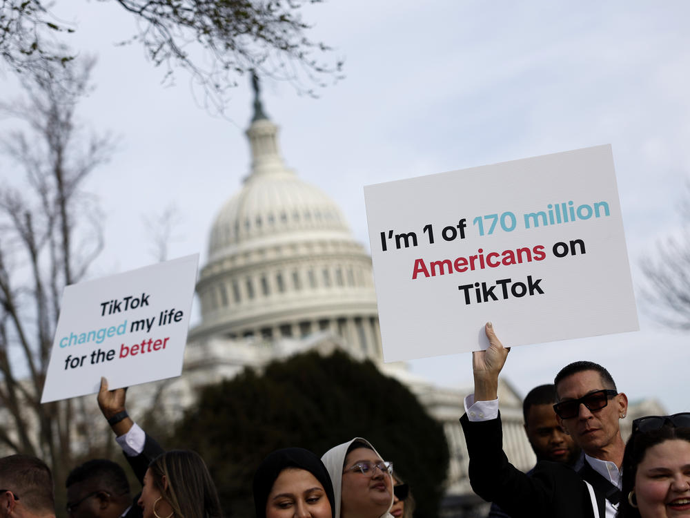 People hold signs in support of TikTok outside the U.S. Capitol building on March 13.