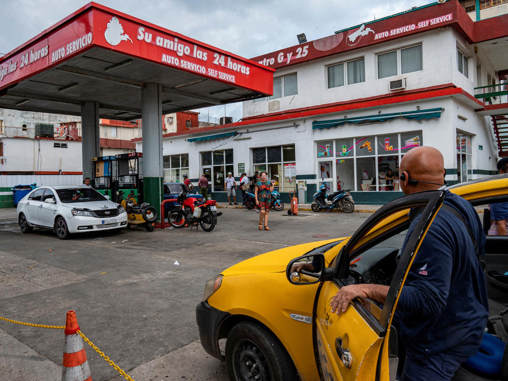 Drivers and motorcyclists line up to fill their tanks at a gas station in Havana, on Jan. 9, a day after the Cuban government announced a 500% hike in fuel prices.