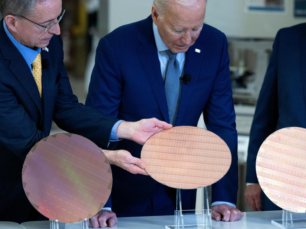 Intel CEO Pat Gelsinger shows President Biden a semiconductor wafer during a tour at the company's Ocotillo Campus in Chandler, Ariz. on March 20.