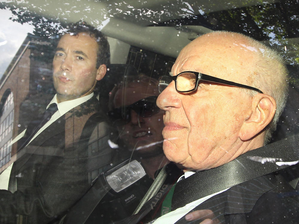 Media mogul Rupert Murdoch (right) rides with Will Lewis, then the general manager of Murdoch's News International and now <em>The Washington Post</em>'s CEO, in July 2011.