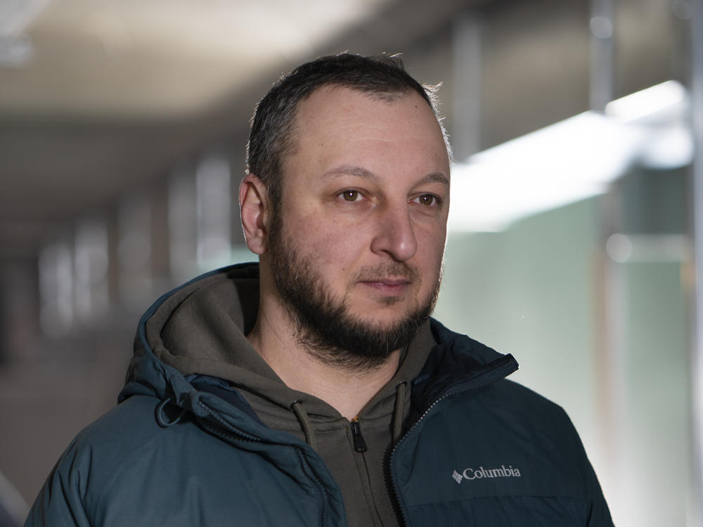 Yevhen Pasenov, Kharkiv's deputy director for housing and communal services, checks in on a construction site for an underground school being built.