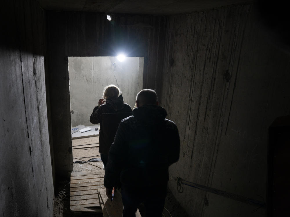 People walk down the stairs to the underground school being built in Kharkiv.