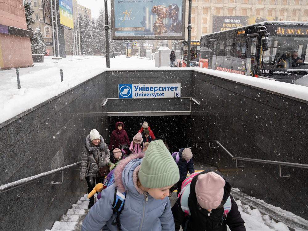 Students leave the underground school built in a Kharkiv subway station to board a bus home.
