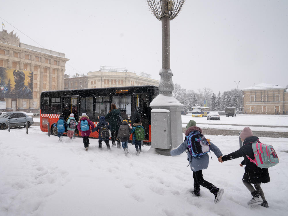 At the end of the school day, students leave the underground classroom to board a bus home.