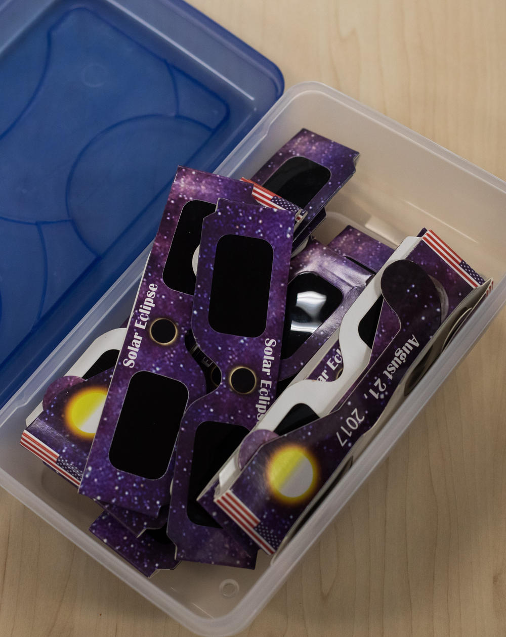 The only way to safely look directly at a total solar eclipse is by looking through special glasses like these, or by creating a pinhole viewer. But be sure to take the glasses off during the few minutes when totality happens, so you don't miss the sun's dim corona.