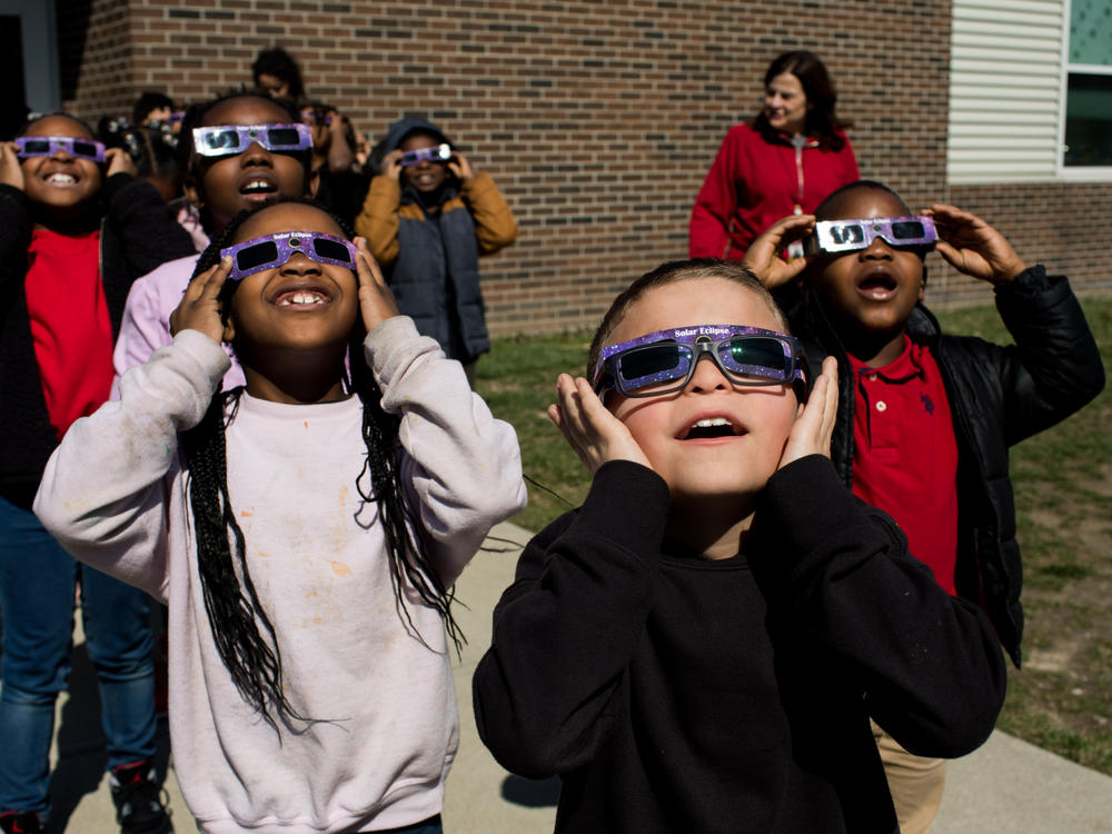 Second graders practice using solar eclipse glasses outside Winchester Village Elementary School in Indianapolis.
