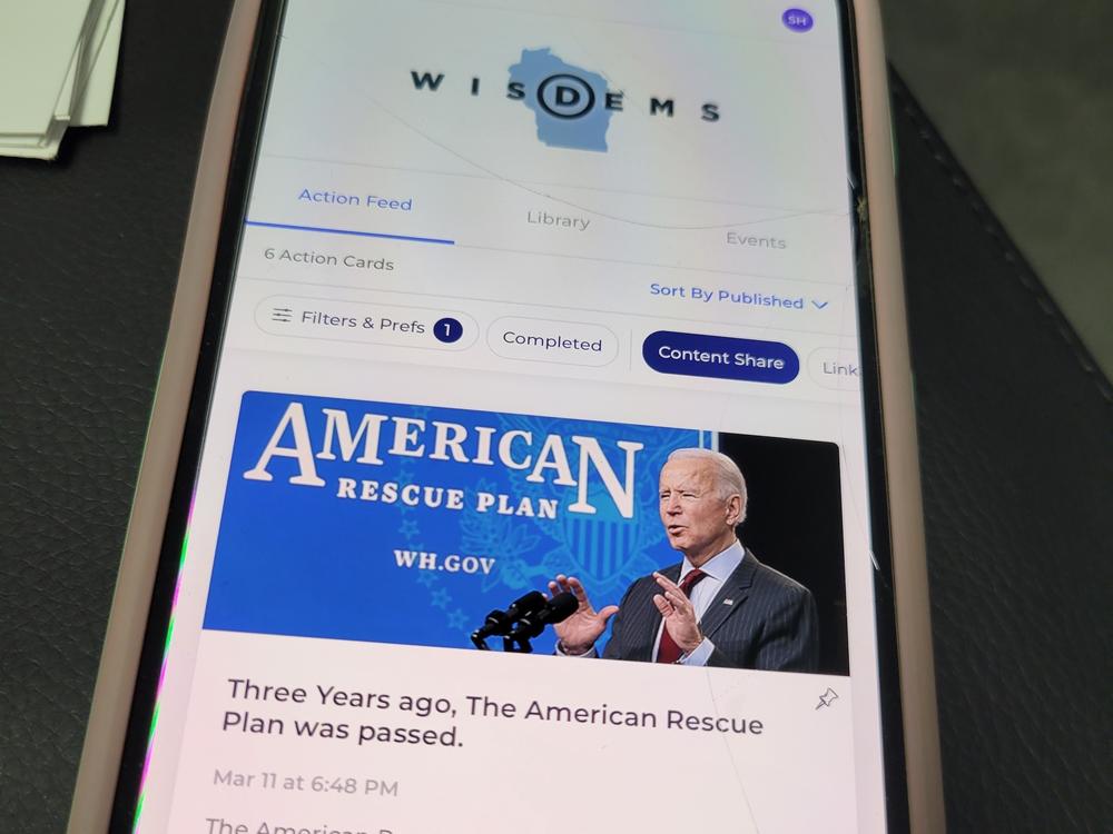 The Reach app, as seen on volunteer Sarah Harrison's phone, allows Biden supporters to share content directly with their contacts, and is connected to a national Democratic party voter database.