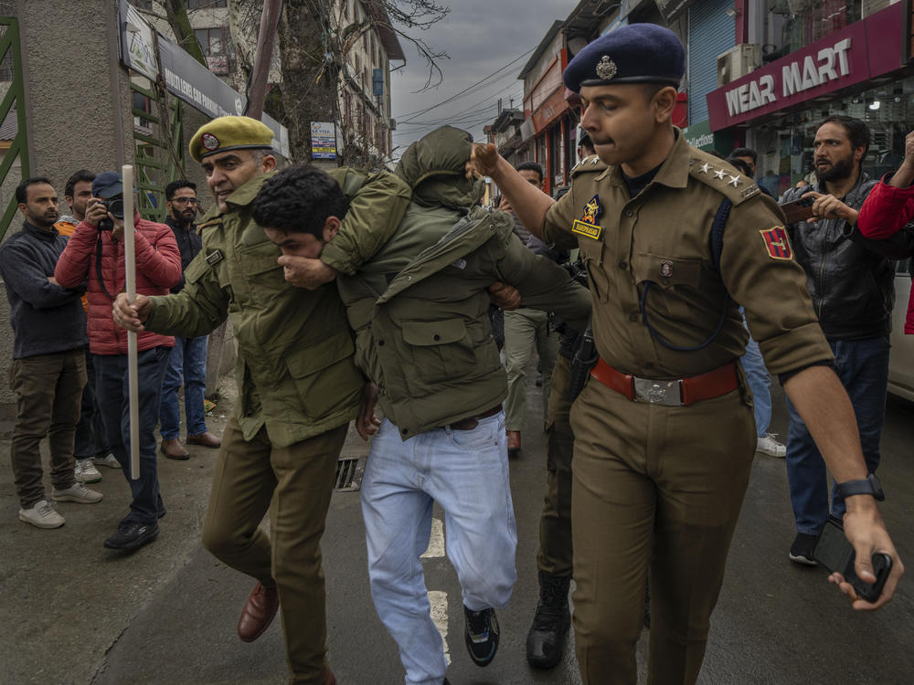 Police officers detain a member of Aam Admi Party, or Common Man's Party, during a protest against the arrest of their party leader Arvind Kejriwal, in Srinagar, Indian-controlled Kashmir, on Friday.