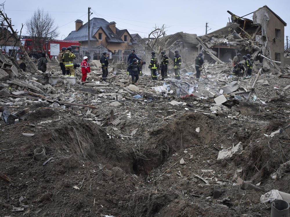 Ukrainian emergency workers clear the debris at the site of Russia's air attack, in Zaporizhzhia, Ukraine, Friday, March 22, 2024.
