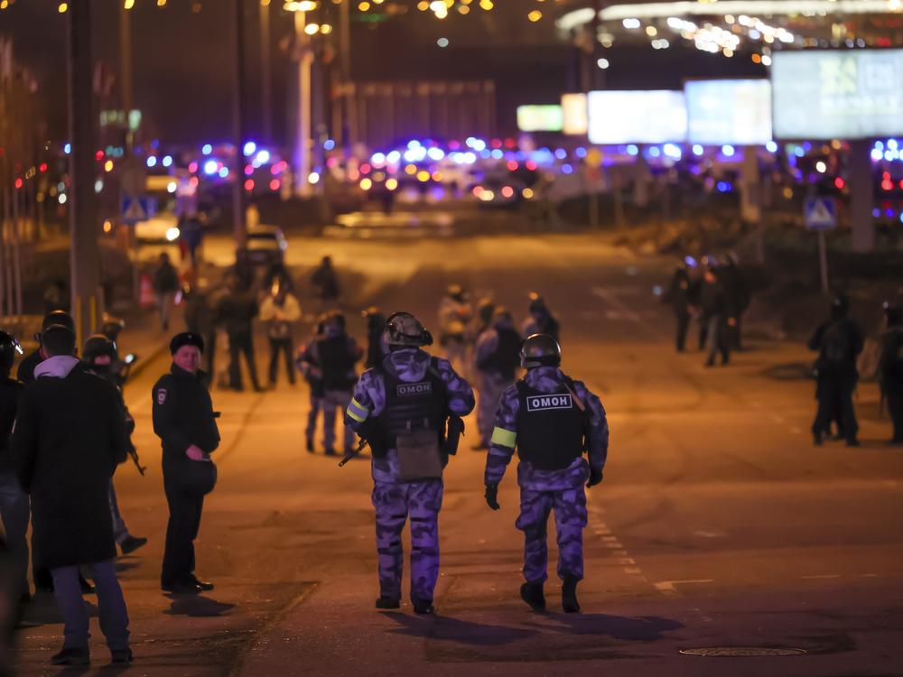 Russian Rosguardia (National Guard) servicemen secure an area near the Crocus City Hall on the western edge of Moscow on Friday after gunmen entered a concert hall and opened fire, killing at least 115.