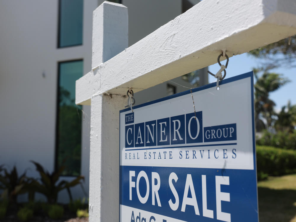 A 'For Sale' sign is posted on the lawn in front of a home on March 15, 2024, in Miami, Fla. The National Association of Realtors announced that it had reached a nationwide $418 settlement of claims that the industry had conspired to keep agent commissions high.