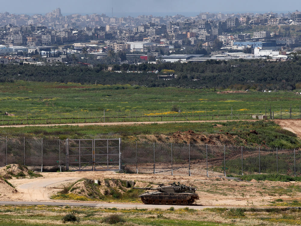 This picture taken from Israel's southern border with the Gaza Strip shows an Israeli army tank moving along the border with the Palestinian territory on March 20.
