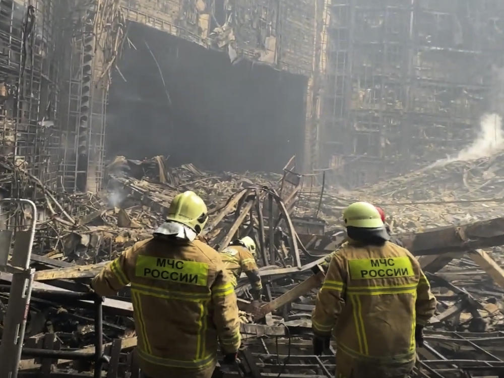 Firefighters work in the burned concert hall after an attack on the western edge of Moscow, Russia. ISIS-K has claimed responsibility for the attack.