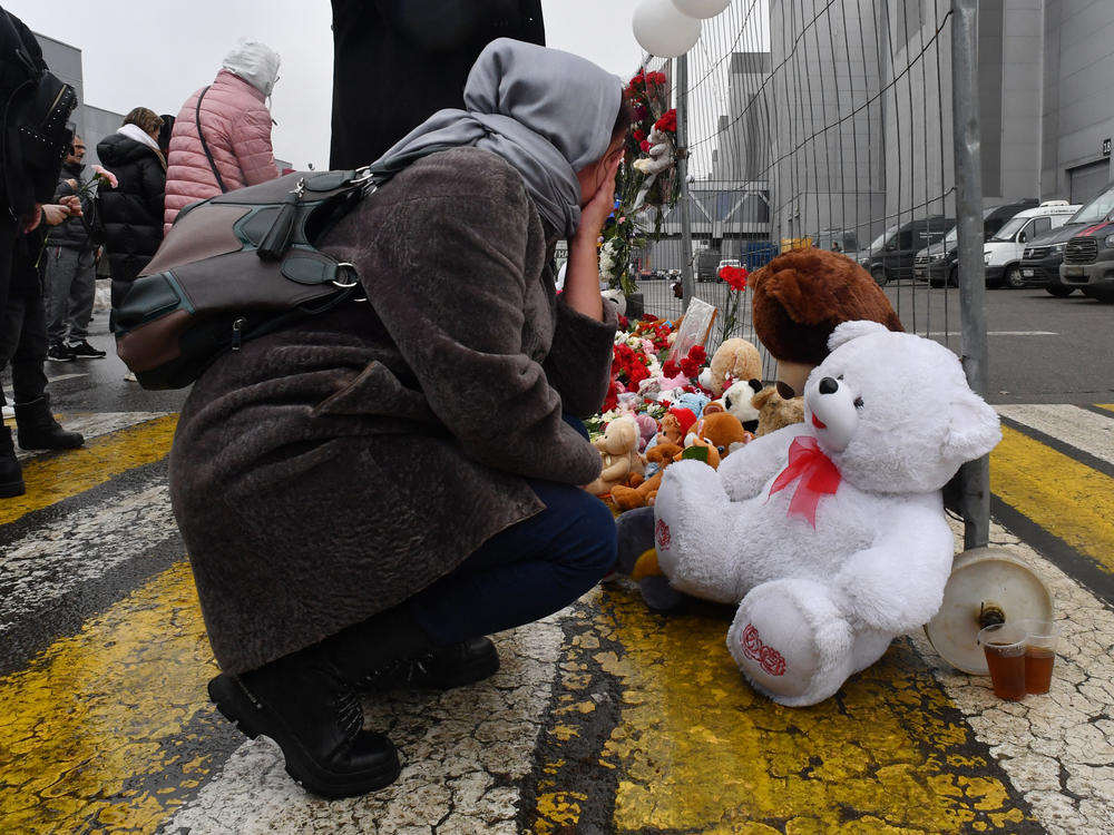 A woman mourns at a makeshift memorial in front of the Crocus City Hall on Saturday, a day after a gun attack in Krasnogorsk, outside Moscow, killed at least 133 people.