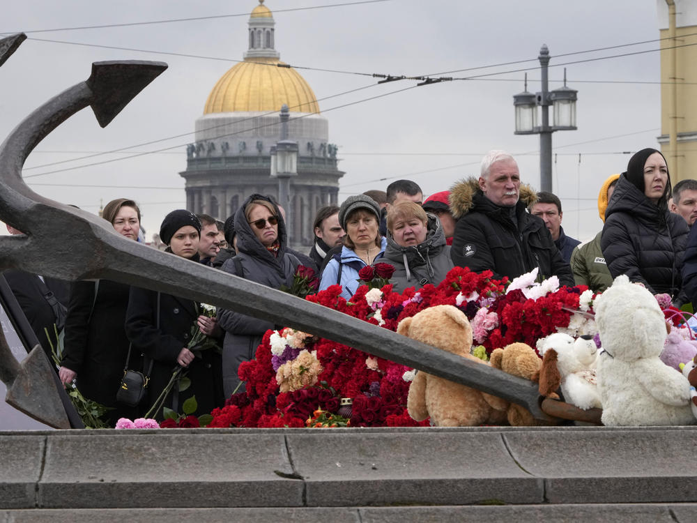 People lay flowers at a spontaneous memorial in memory of the victims of Moscow attack in St. Petersburg, Russia, on Sunday.