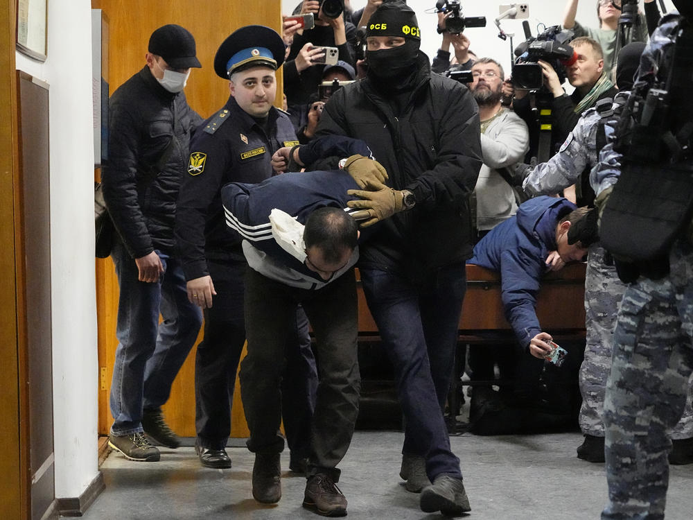 Saidakrami Murodali Rachabalizoda, a suspect in the Crocus City Hall shooting on Friday, is escorted by police and FSB officers in the Basmanny District Court in Moscow, Russia, Sunday, March 24, 2024.