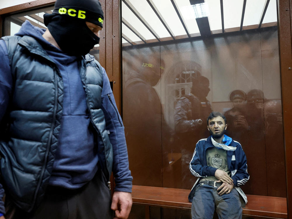 Dalerdzhon Mirzoyev, a suspect in the shooting attack at the Crocus City Hall concert venue, sits behind a glass wall of an enclosure for defendants at the Basmanny district court in Moscow, March 24.
