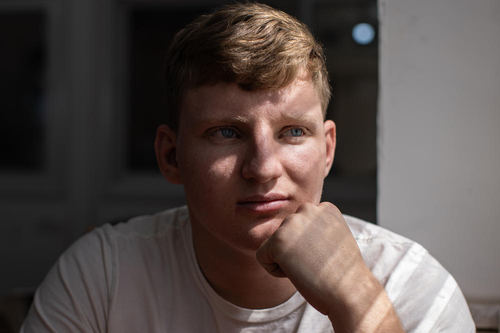 Binyamin Savrasov, 19, a student at Yeshiva Chedvata, sits for a portrait in a classroom at the yeshiva on March 20. 