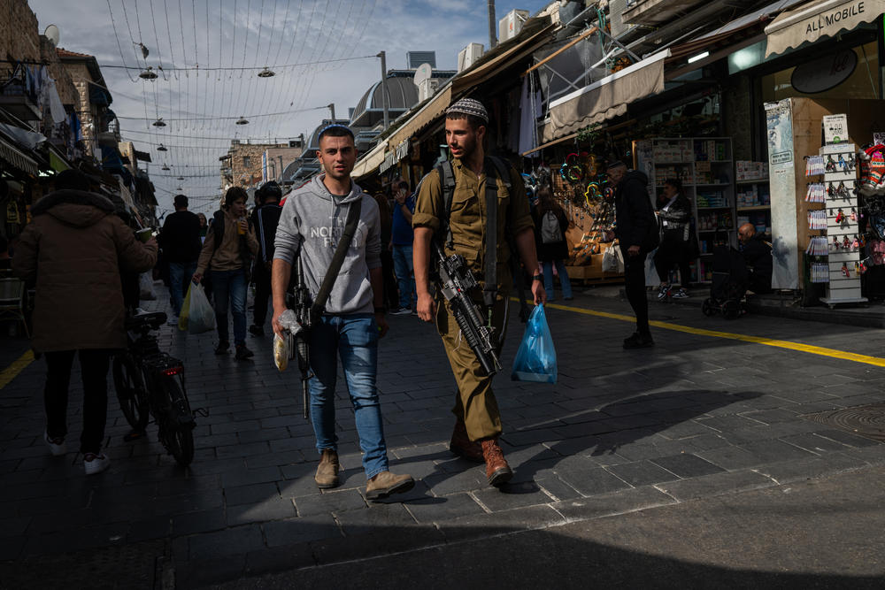 Israeli soldiers walk through the Machane Yehuda market in Jerusalem on March 21.