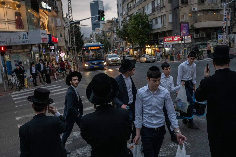 Ultra-Orthodox Jewish men cross a street in Bnei Brak, Israel, on March 21. Full-time religious students have been broadly exempt from military service in Israel since the nation's founding 76 years ago.
